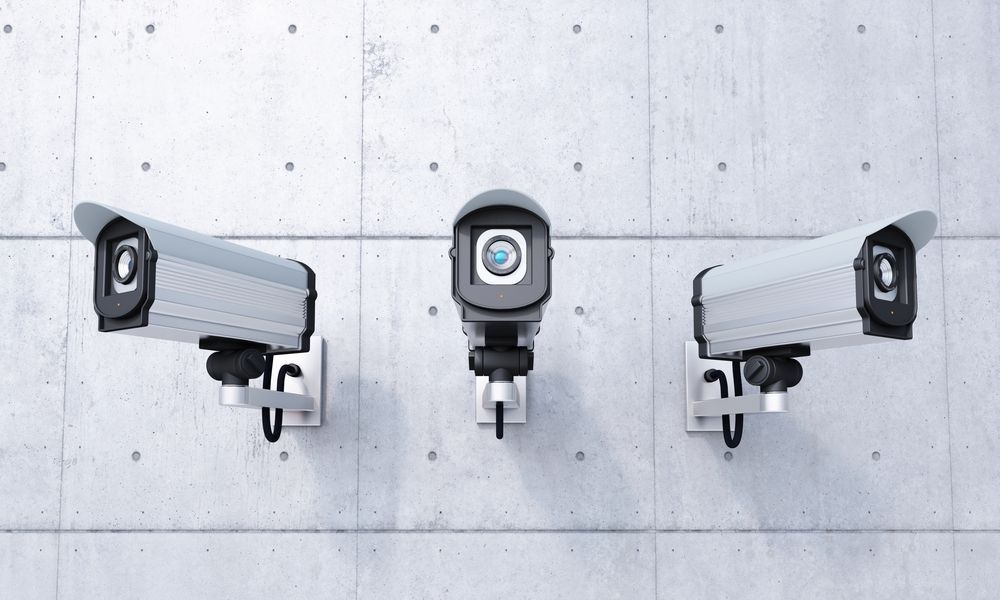 Three Surveillance Cameras Mounted on a Gray Concrete Wall — NQ Video Surveillance in Mission Beach, QLD