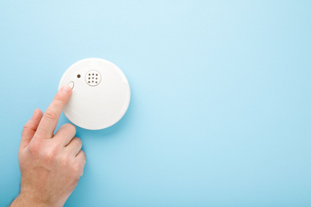 Hand Pressing the Test Button — NQ Video Surveillance in Port Douglas, QLD