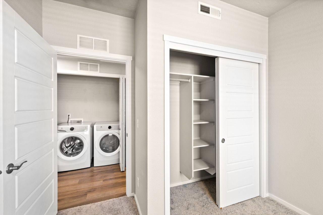 Laundry closet with front-loading washer and dryer.