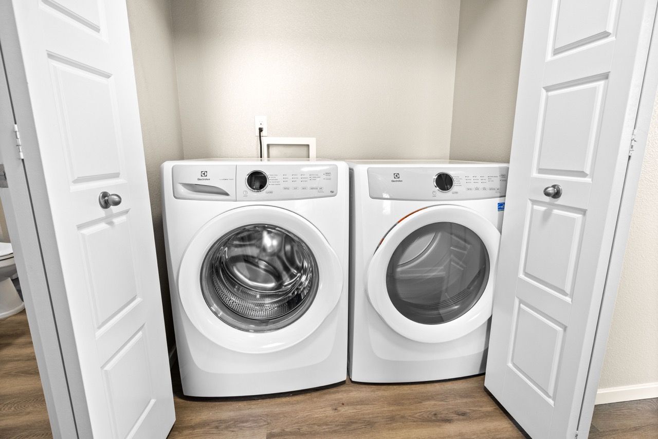 Front-loading washer and dryer in a small laundry closet.