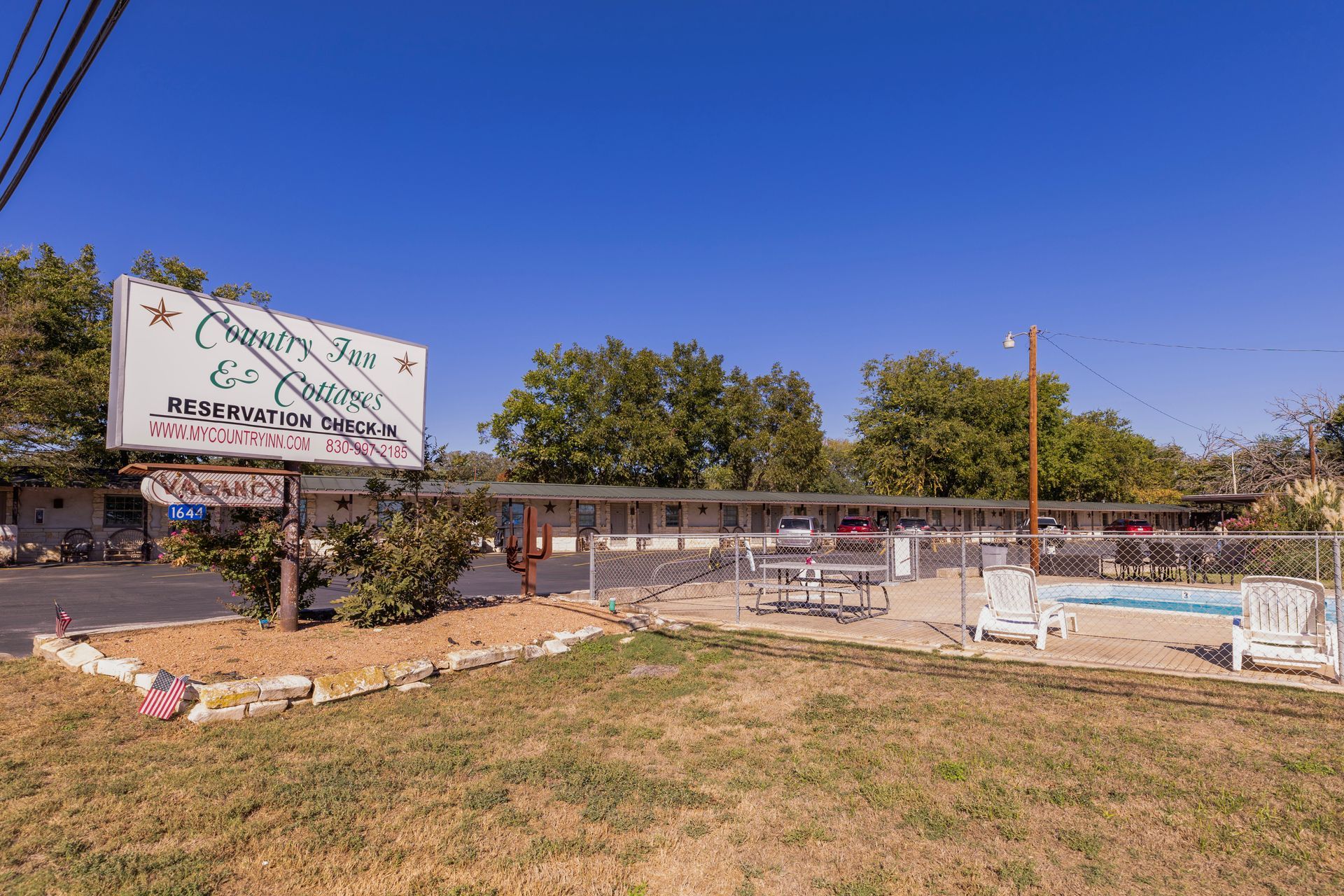 Motel with a pool; sign reads 