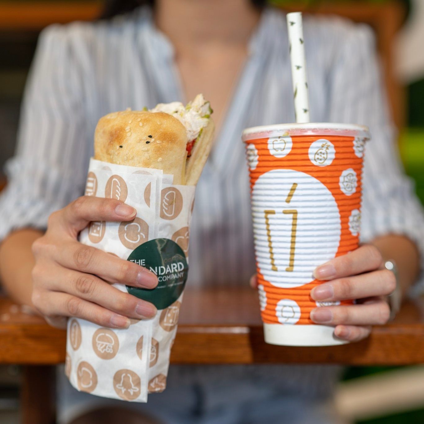 Woman Holding Focaccia and Drink — Quench Juice Bar in Fortitude Valley, QLD