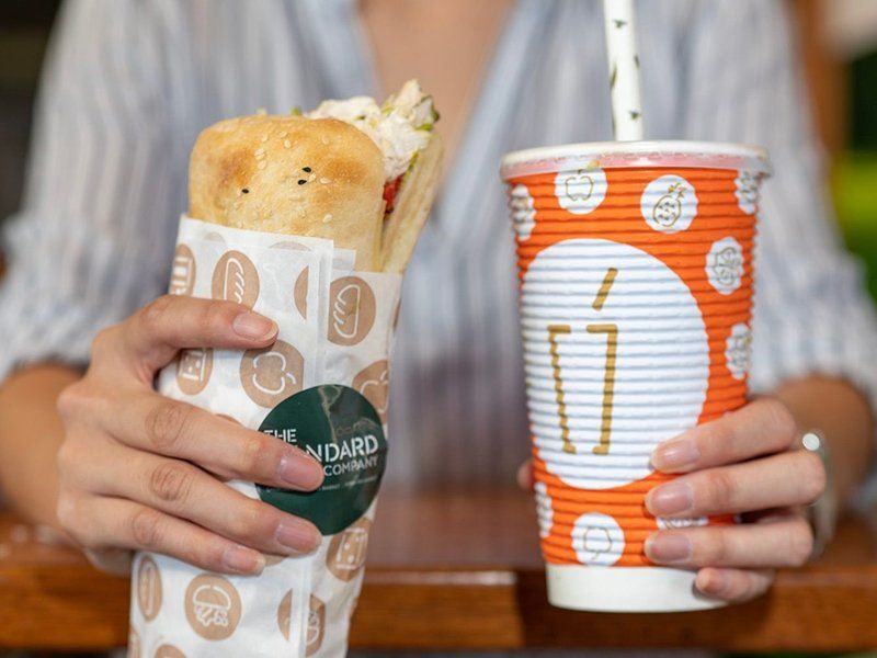 Woman Holding Juice & Focaccia Sandwich — Quench Juice Bar in Fortitude Valley, QLD
