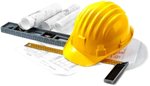 Yellow hard hat on construction blueprints with ruler and rolled plans