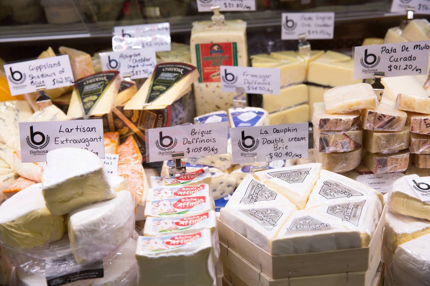 A Display Case Filled With Lots of Different Types of Cheese — Barbosa Fine Food Deli in Robina, QLD