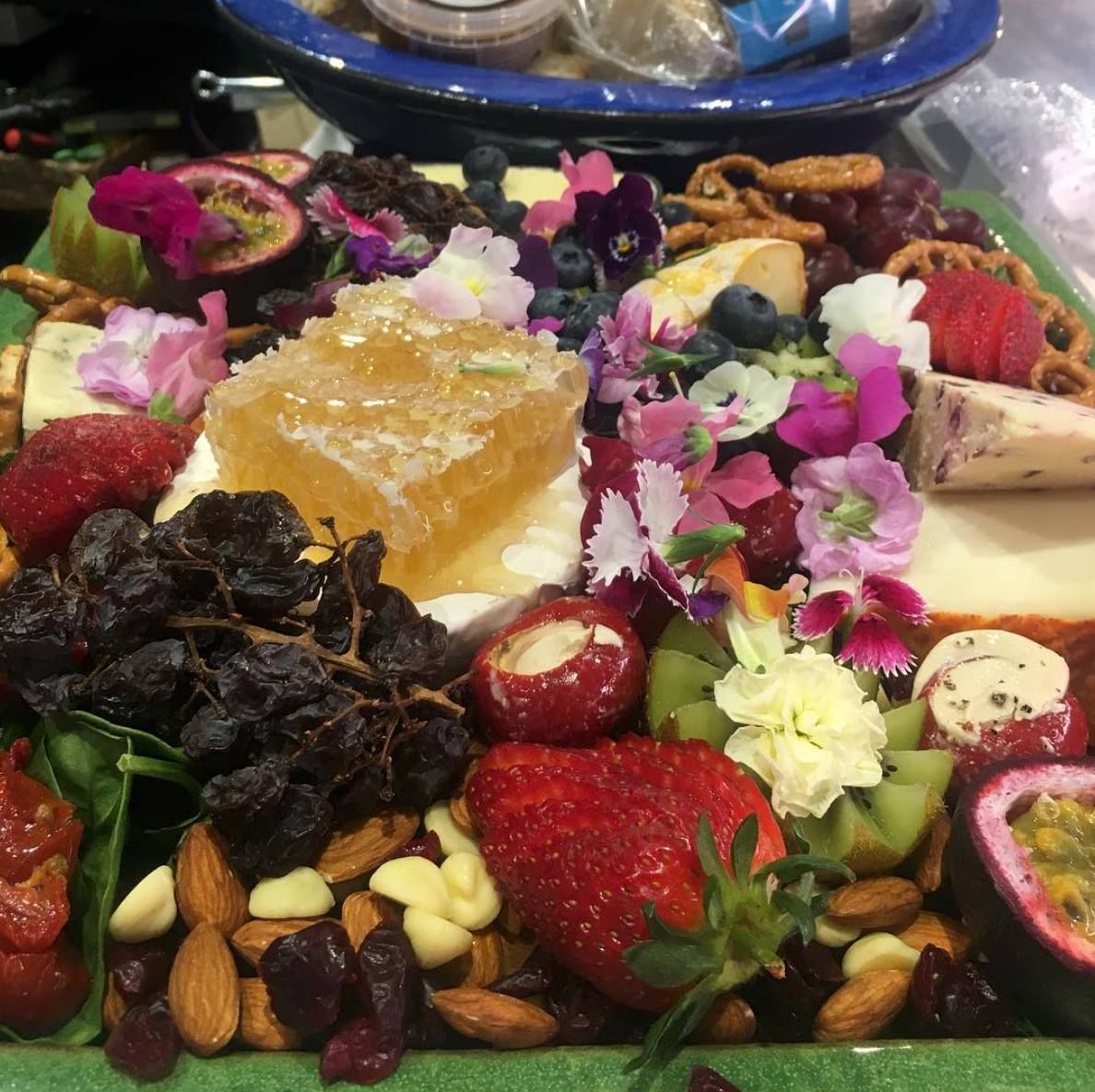 A Variety of Fruits and Nuts on a Green Plate — Barbosa Fine Food Deli in Robina, QLD