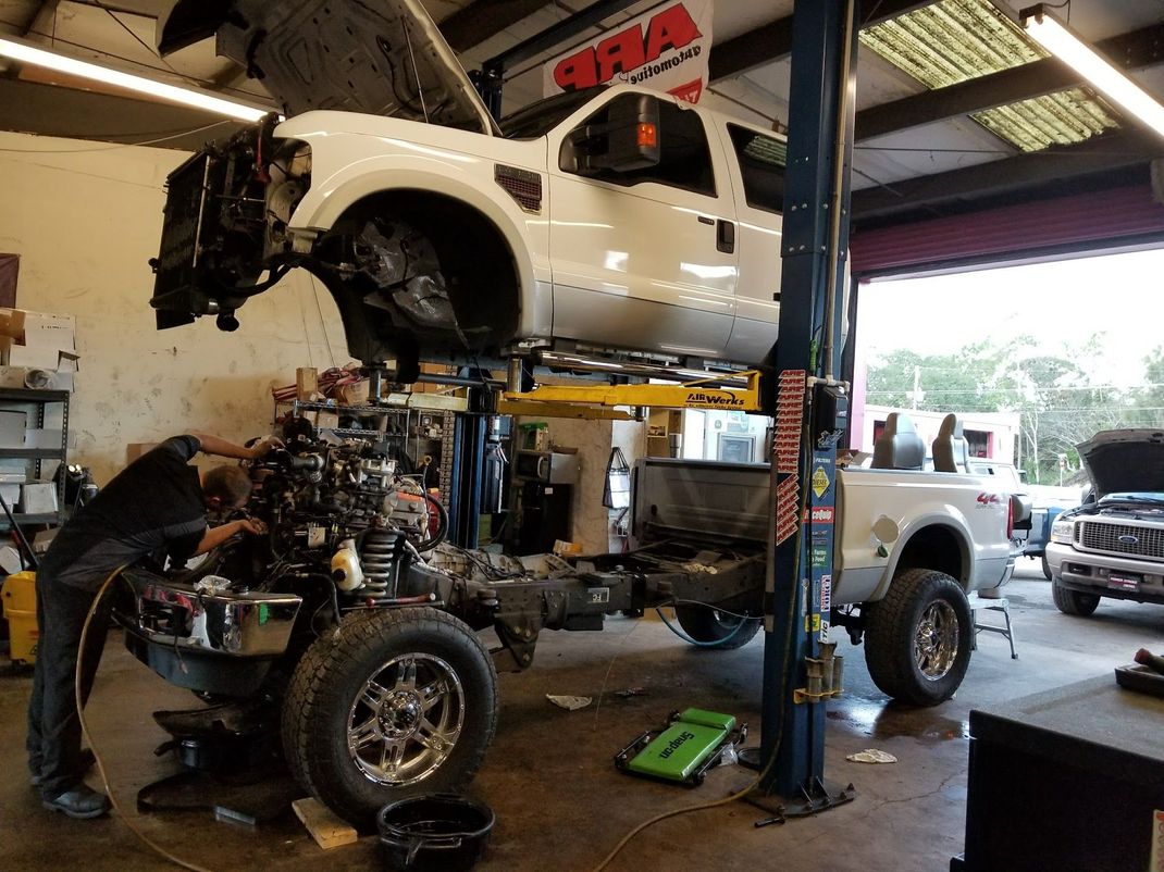 Truck raised on lift in auto shop | Central Florida Diesel Performance