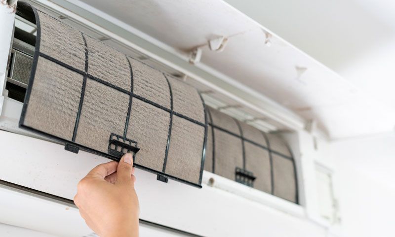 Removing Air Conditioner Filter — Castle Hill, NSW — Brennan Air Conditioning Pty Ltd Removing Air Conditioner Filter — Castle Hill, NSW — Brennan Air Conditioning Pty Ltd