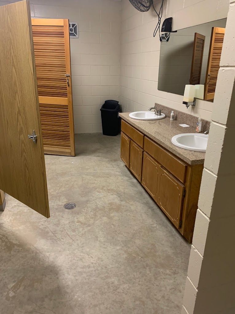 A bathroom with two sinks and a mirror.