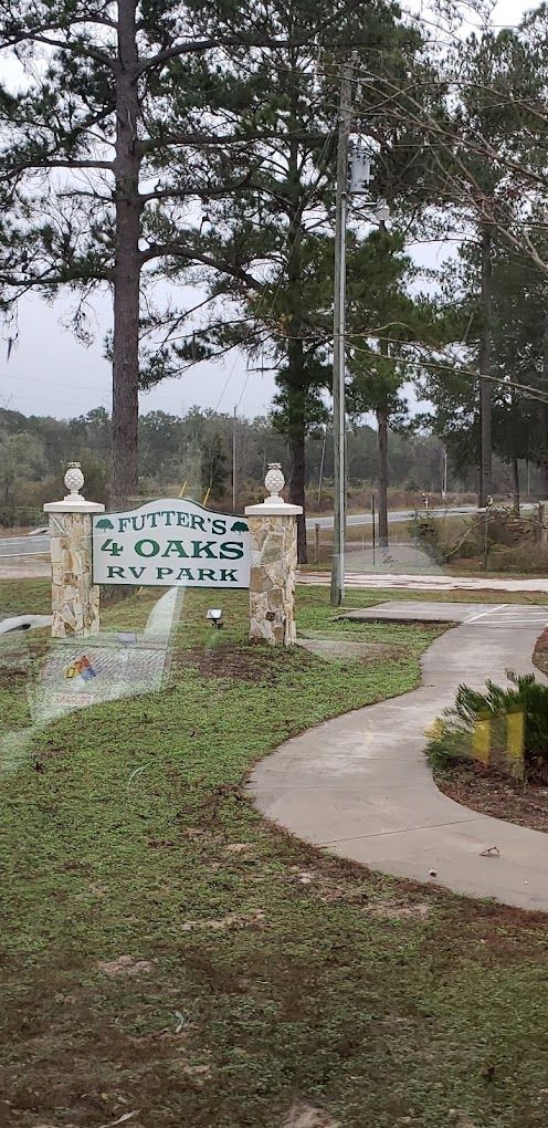 A sign for a park is being sprayed with water.
