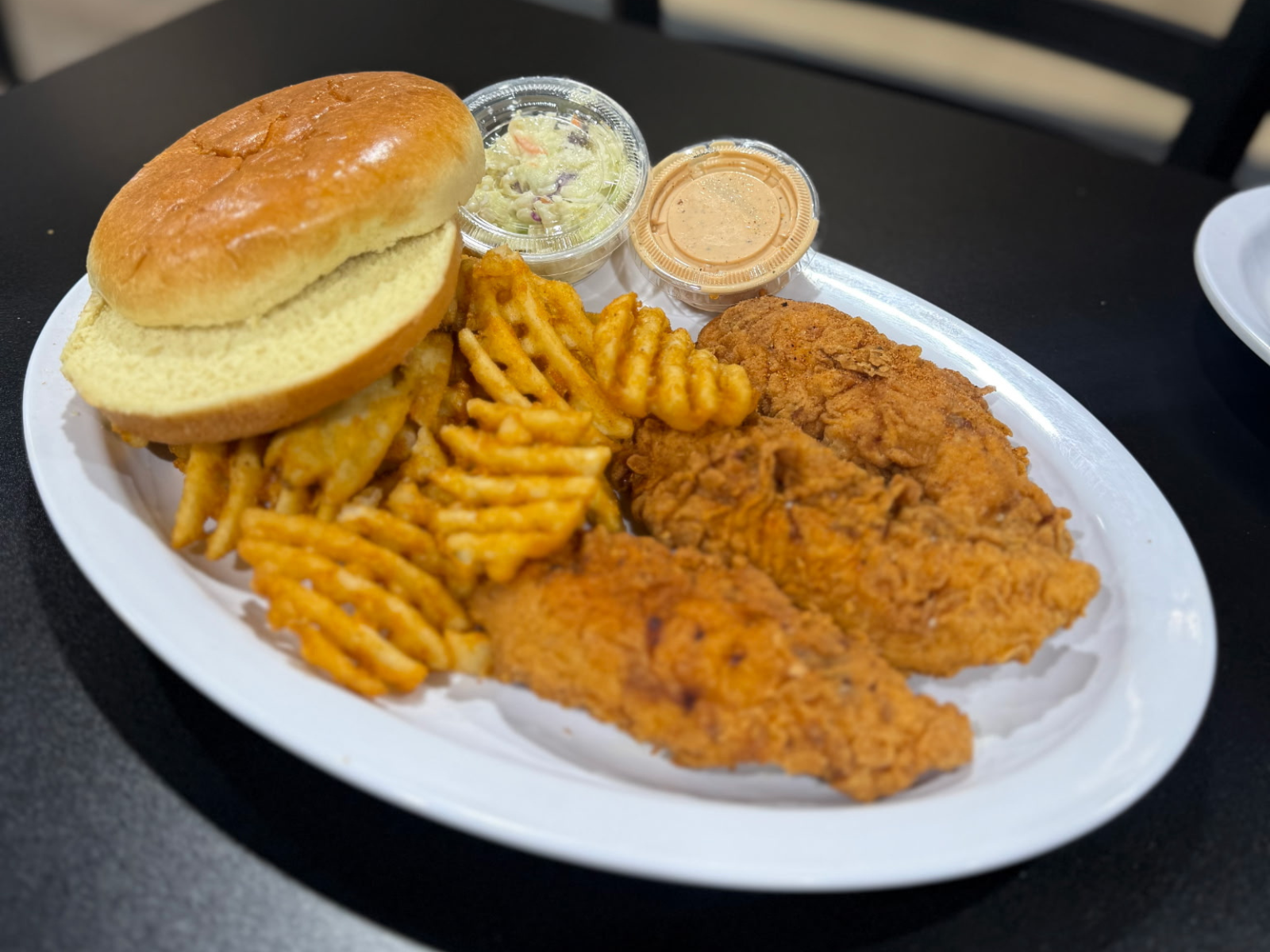 A styrofoam container filled with food is sitting on a table in a store.