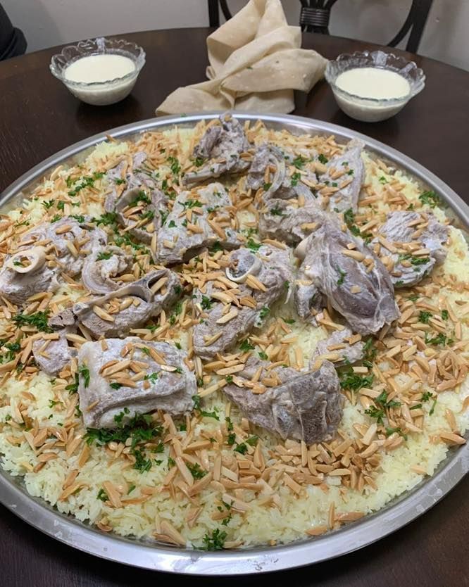 A plate of food with meat and rice on a table.