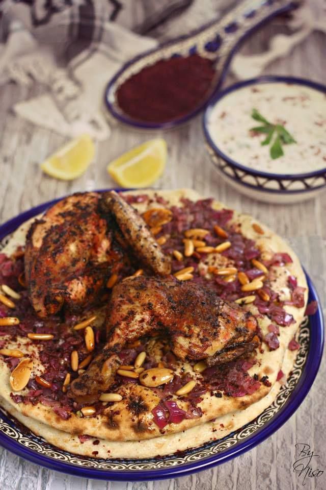 Chicken and bread dish with sumac, pine nuts, and yogurt dip.