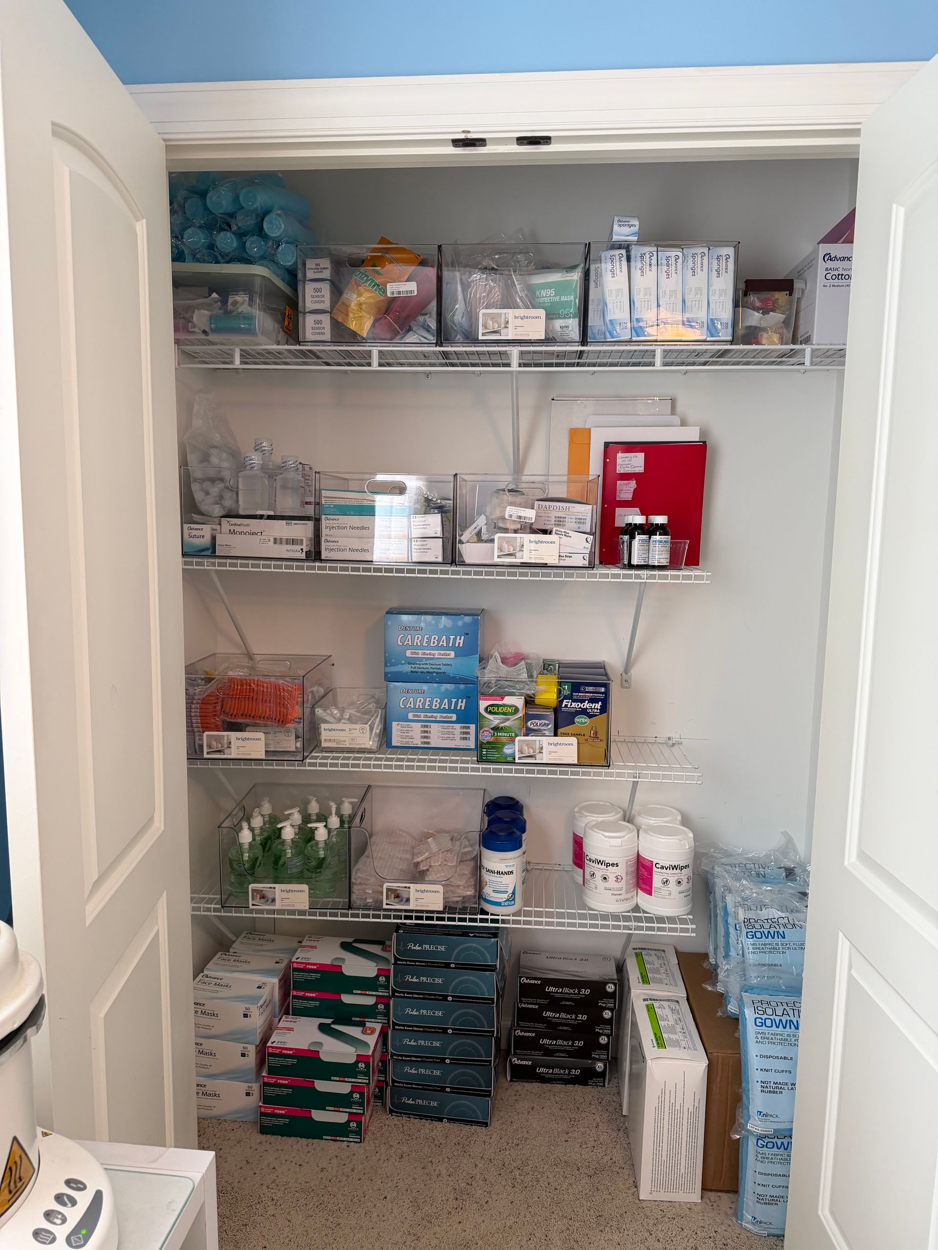 Open pantry with neatly stacked food, toiletries, and supplies on wire shelves