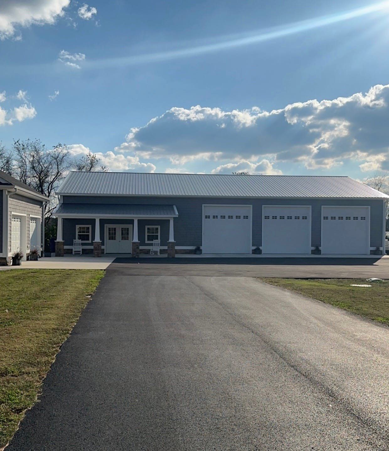A house with three garage doors and a driveway leading to it