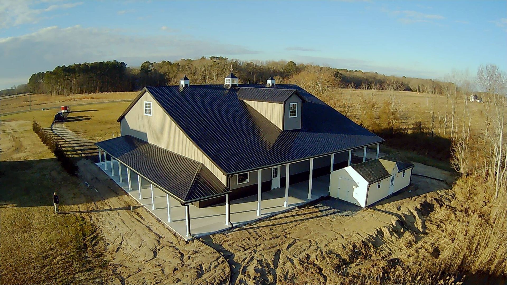 An aerial view of a house with a black roof