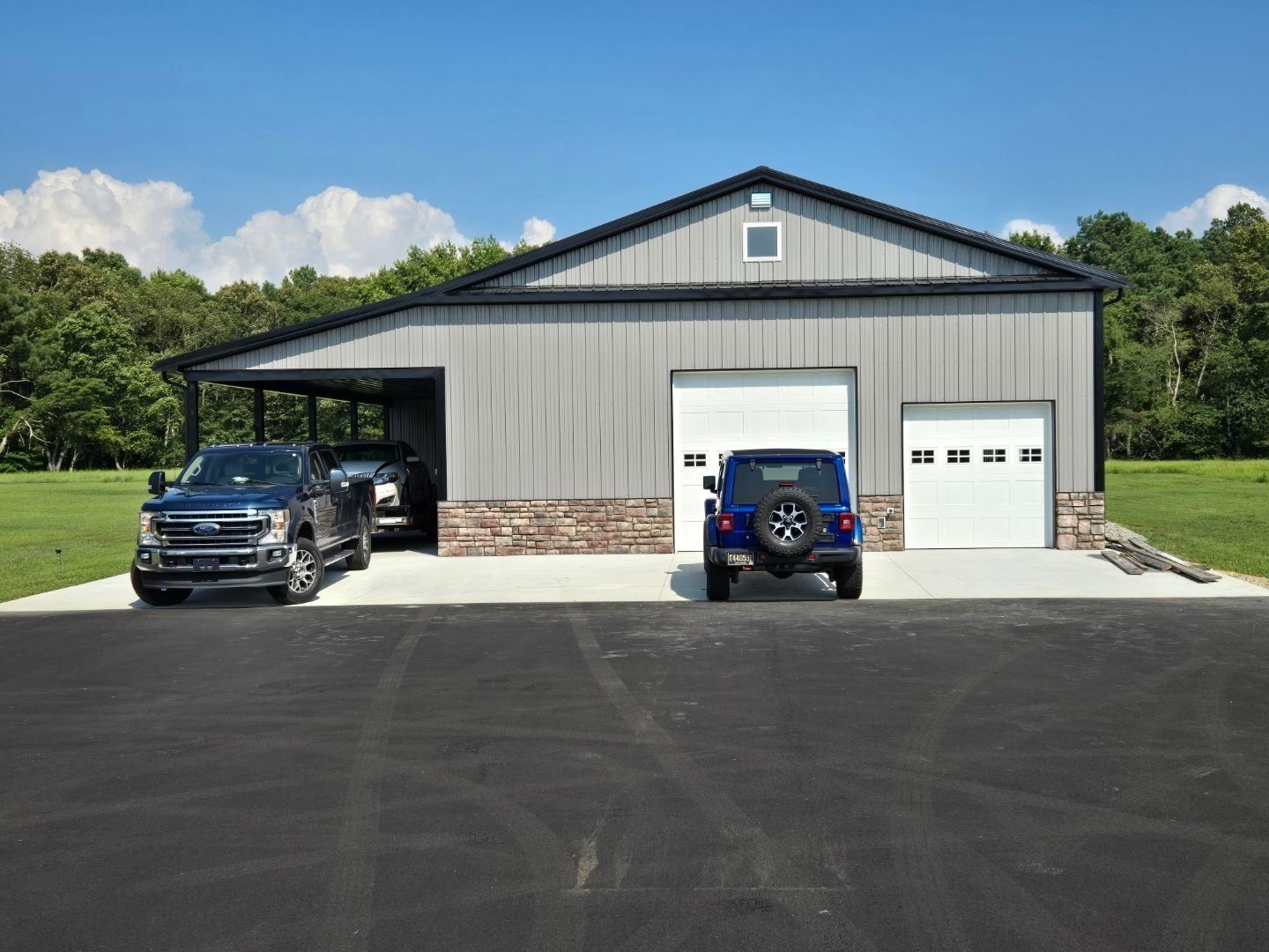 Two cars are parked in front of a garage.