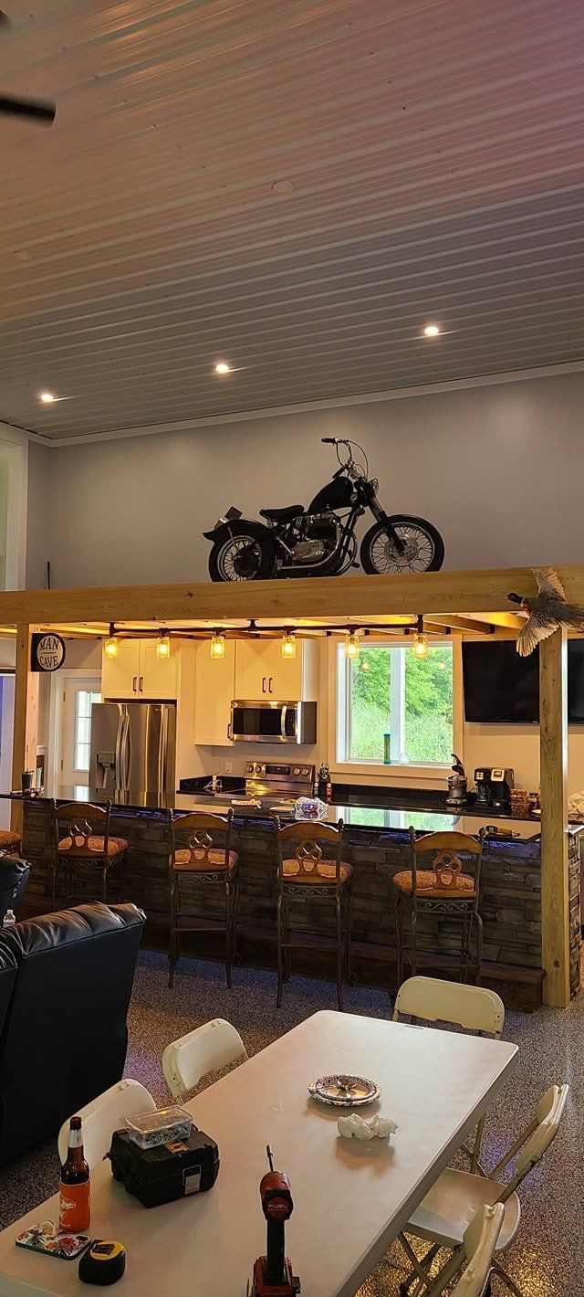 A motorcycle is hanging from the ceiling of a living room.