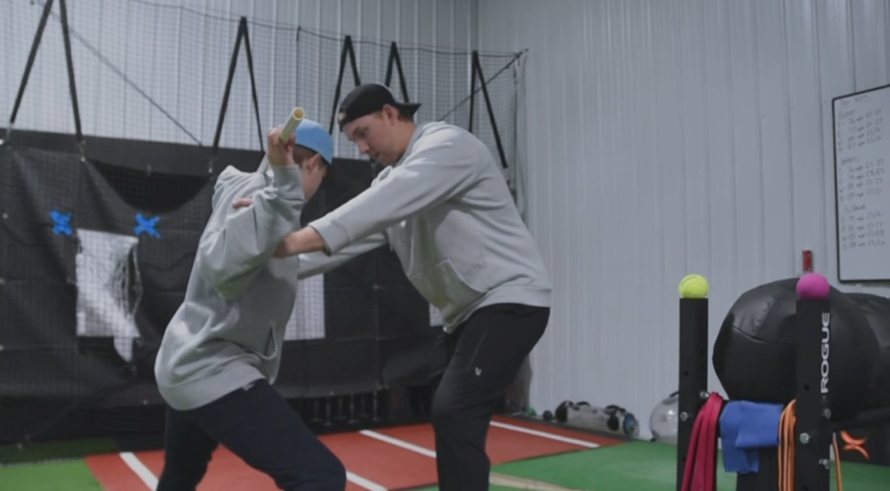 A man and a woman are fighting in a gym.