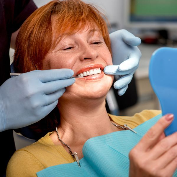 Senior Woman with New Dentures — Paddington, QLD — Essential Dental Group Senior Woman with New Dentures — Paddington, QLD — Essential Dental Group