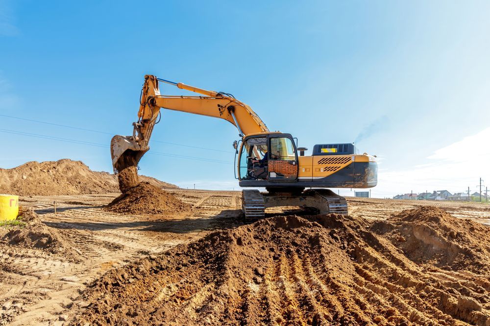 A large excavator is moving dirt on a construction site.