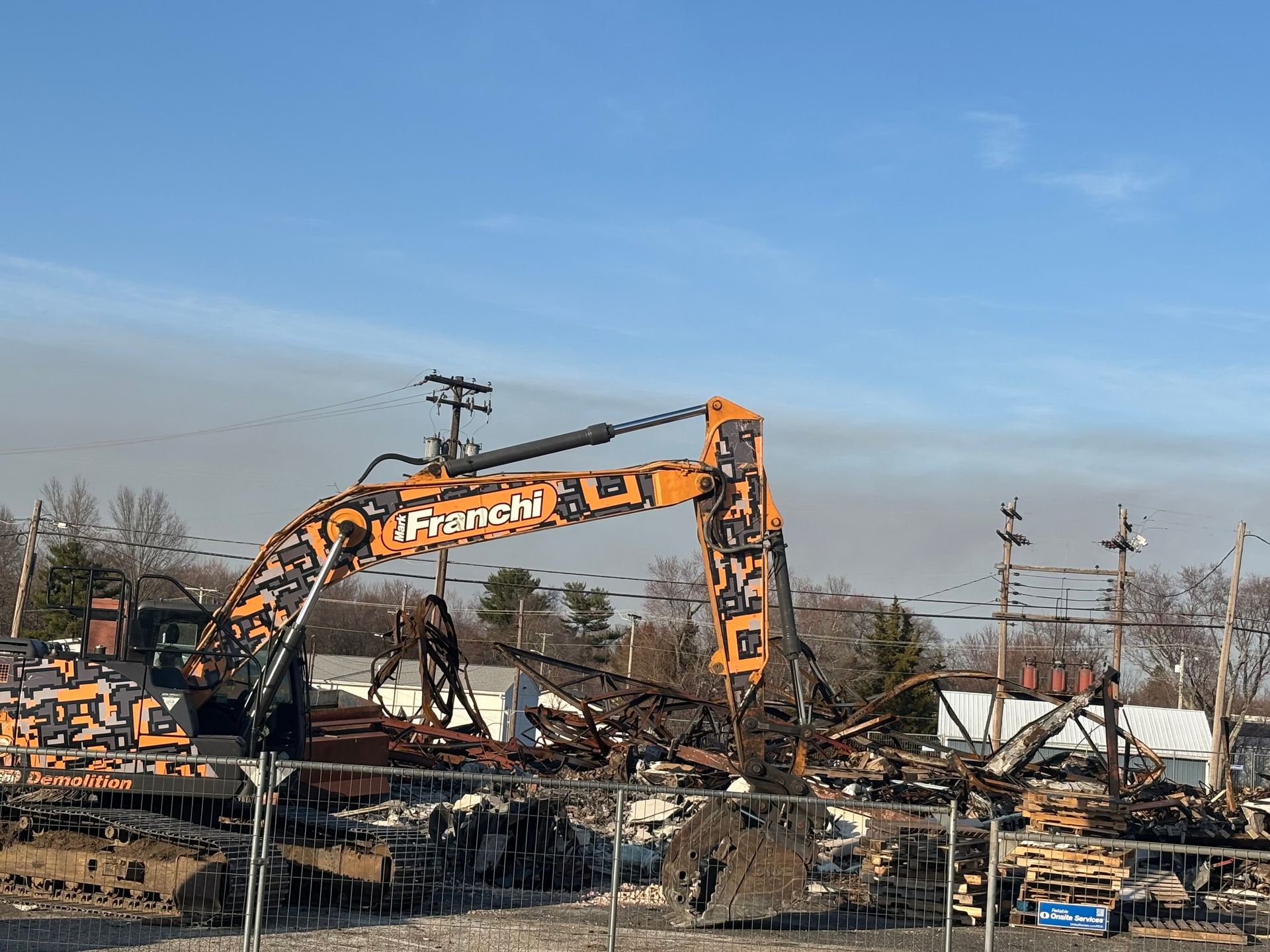 A large excavator is being used to demolish a building.