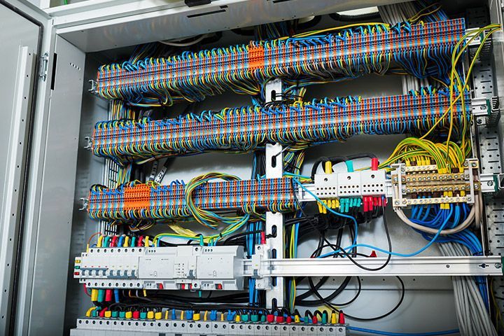 Neat and professional installation of a large commercial electrical panel with clearly labeled high-quality components and secure cable management for industrial safety and efficiency.