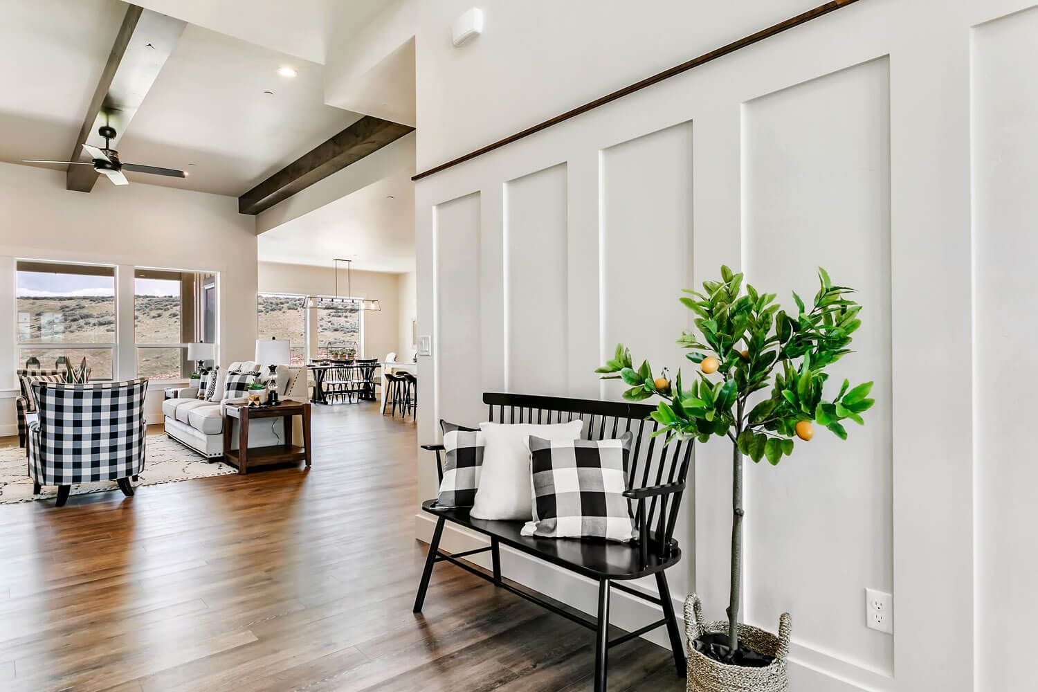 A black and white checkered bench is in the middle of a living room.