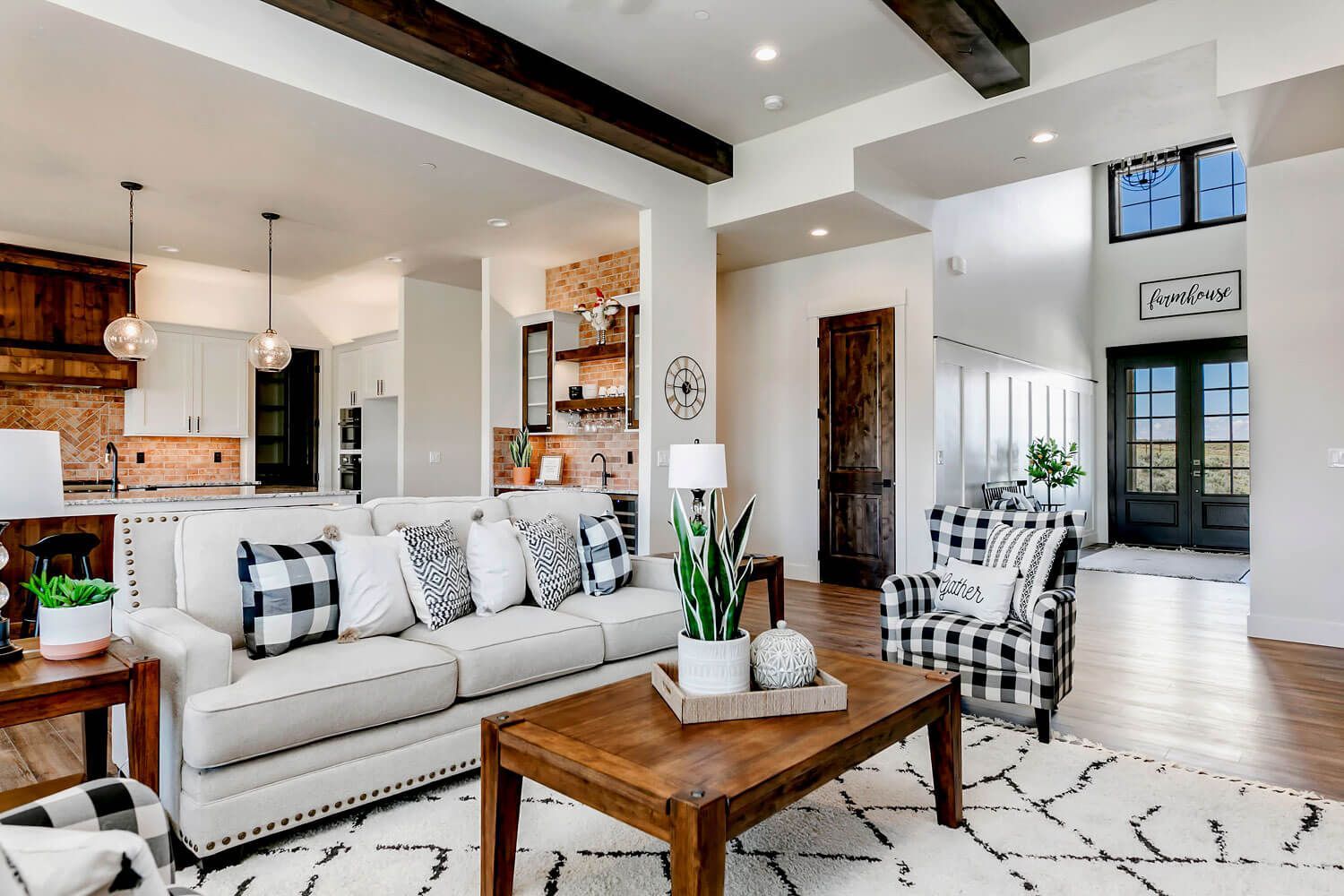 A living room with a couch , chair , coffee table and rug.