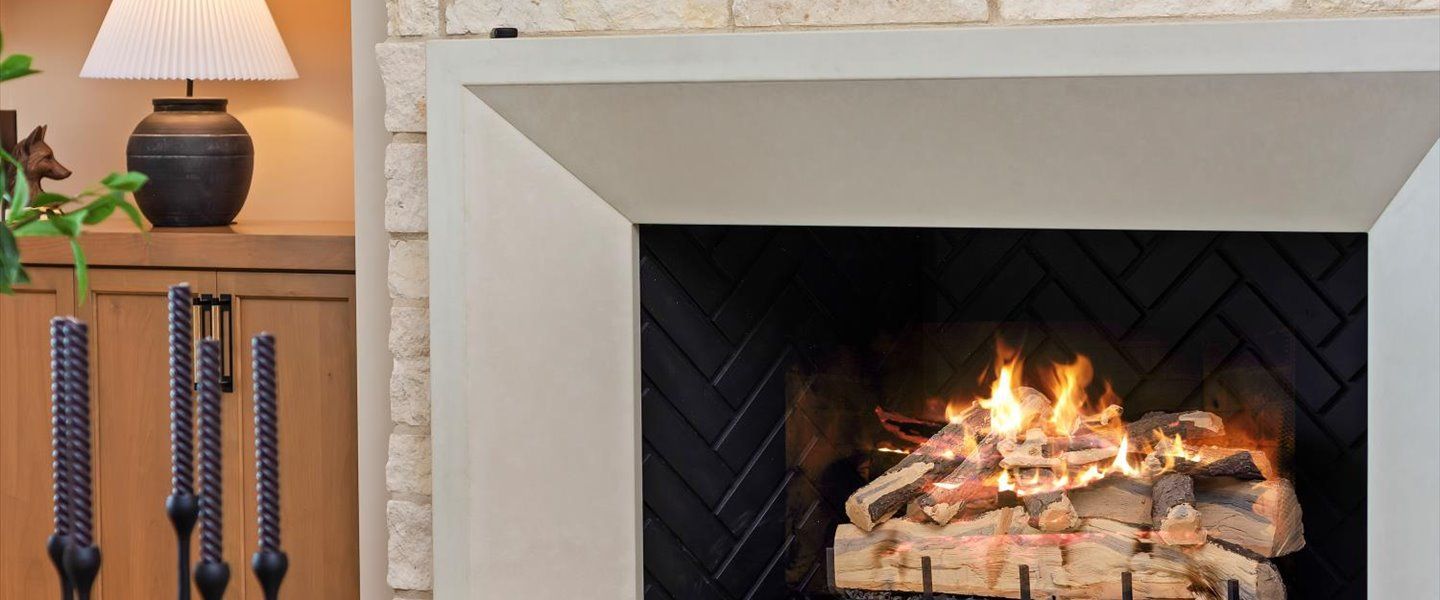 There is a fireplace with a lot of wood in it.