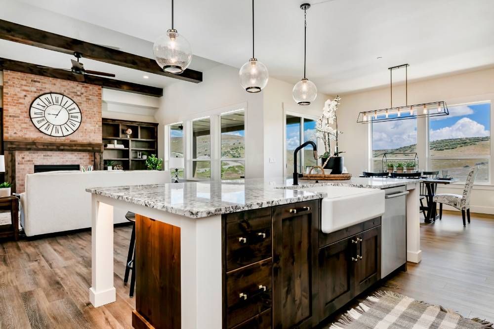 A kitchen with a large island and a clock on the wall.