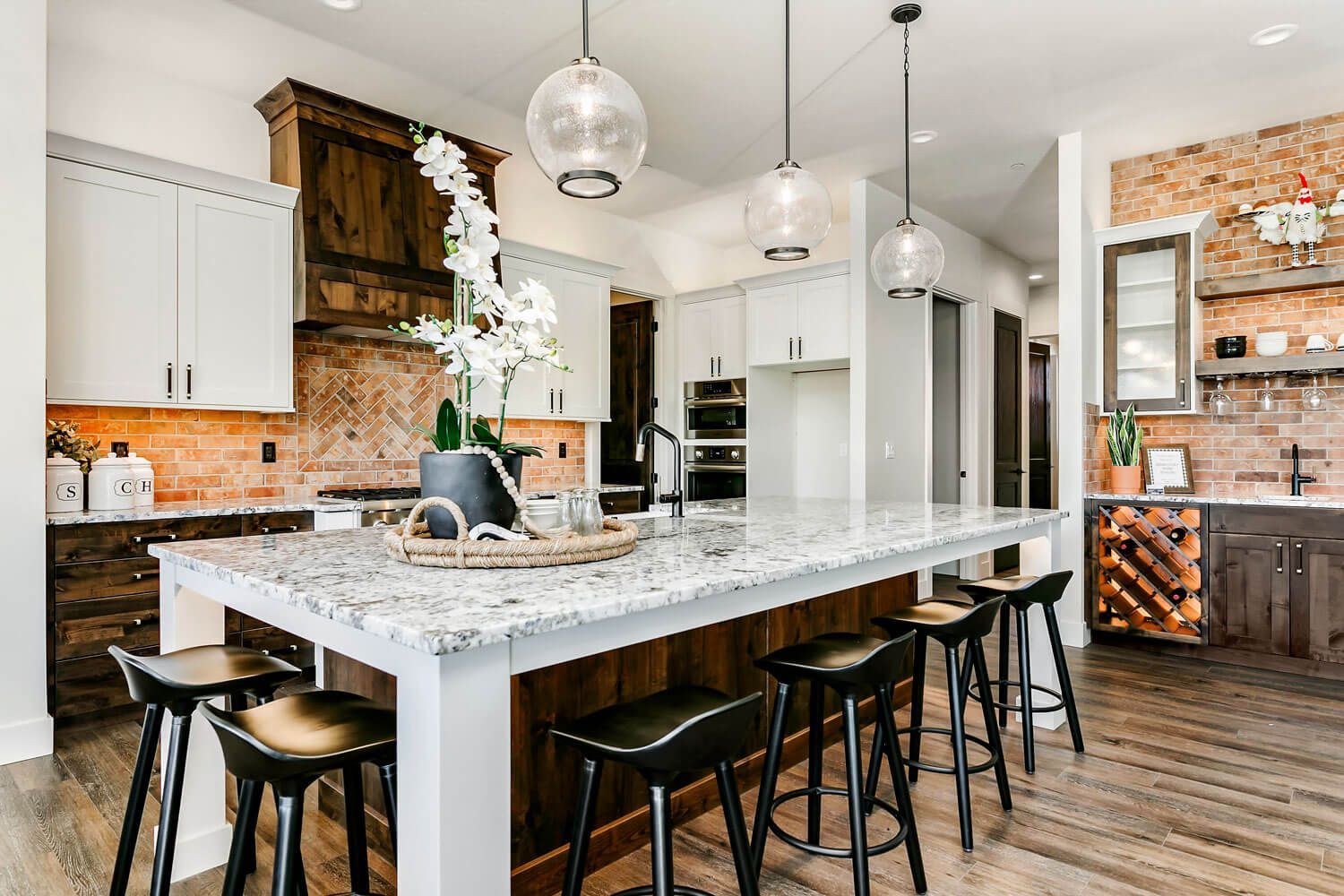 A kitchen with a large island and stools.