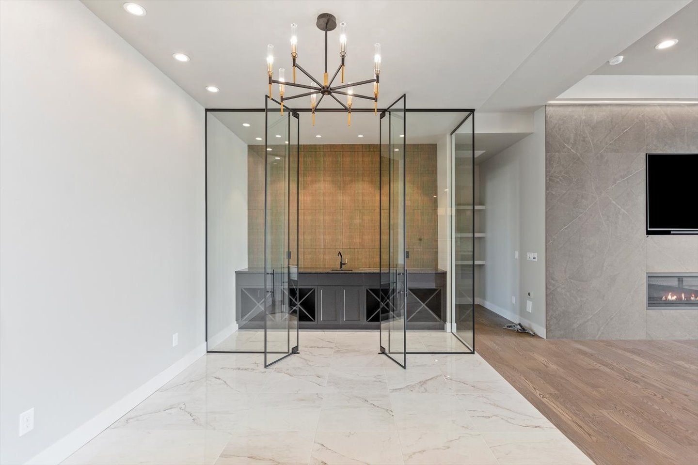 An empty room with sliding glass doors and a flat screen tv