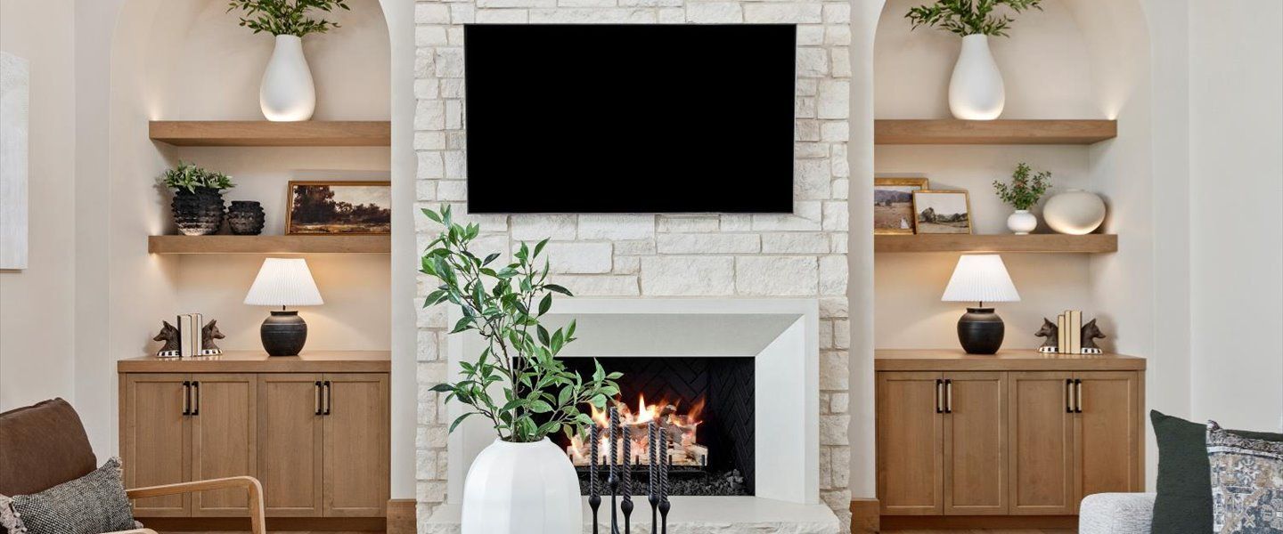 A living room with a fireplace and a flat screen tv.