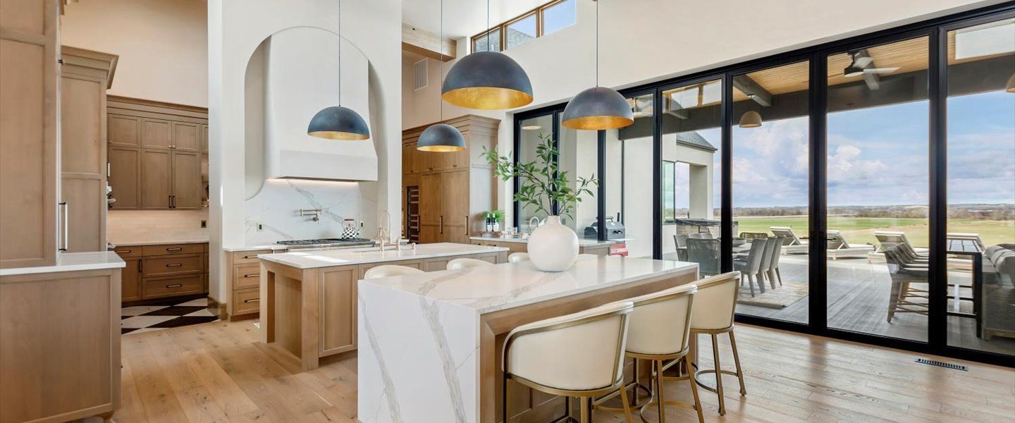 A kitchen and dining room in a house with sliding glass doors.