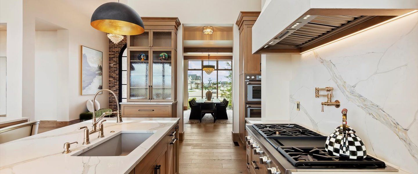 A kitchen with a stove , sink , and refrigerator.