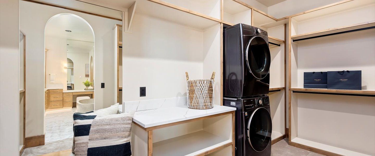 A laundry room with a washer and dryer stacked on top of each other.