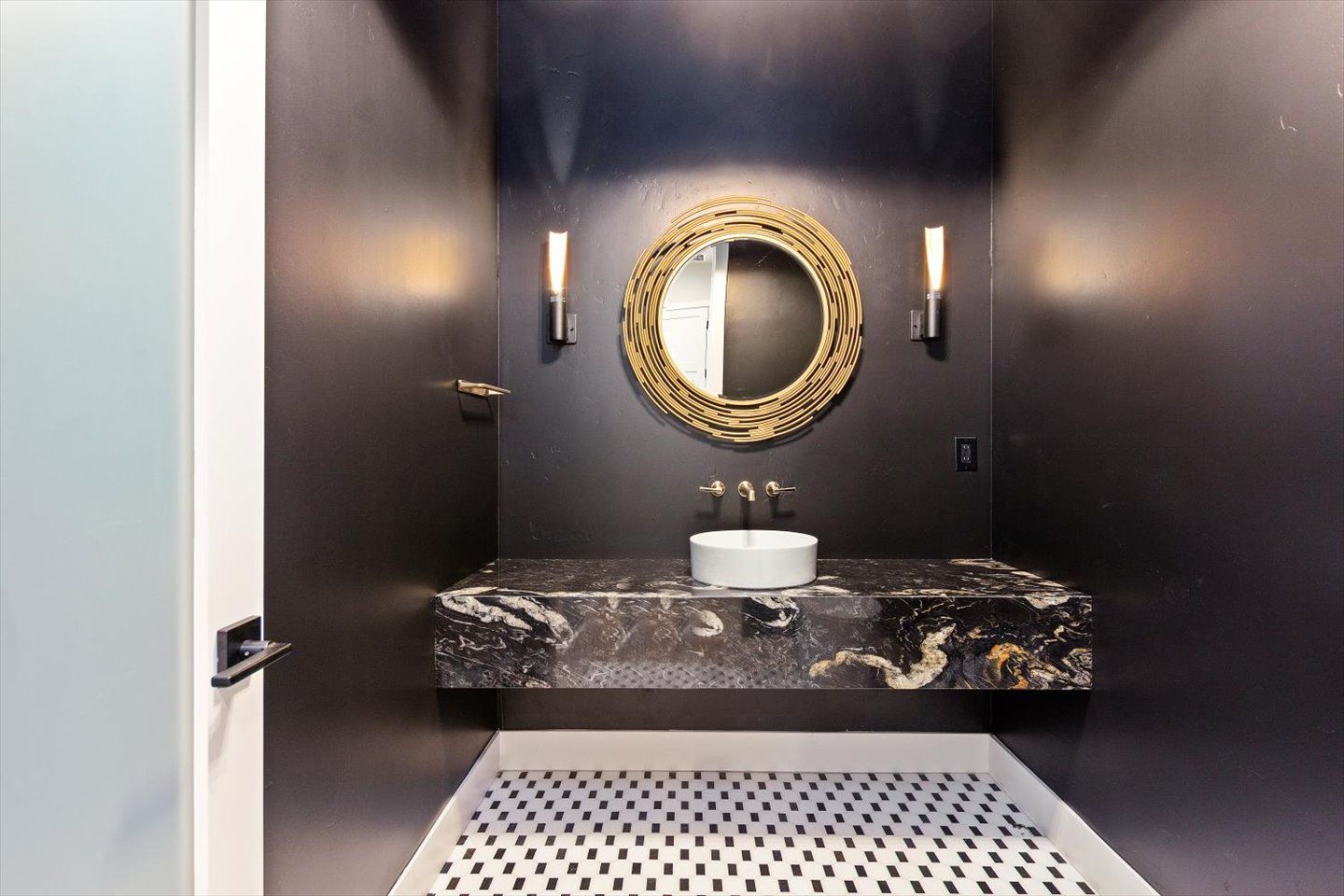 A bathroom with a sink and a mirror on the wall.