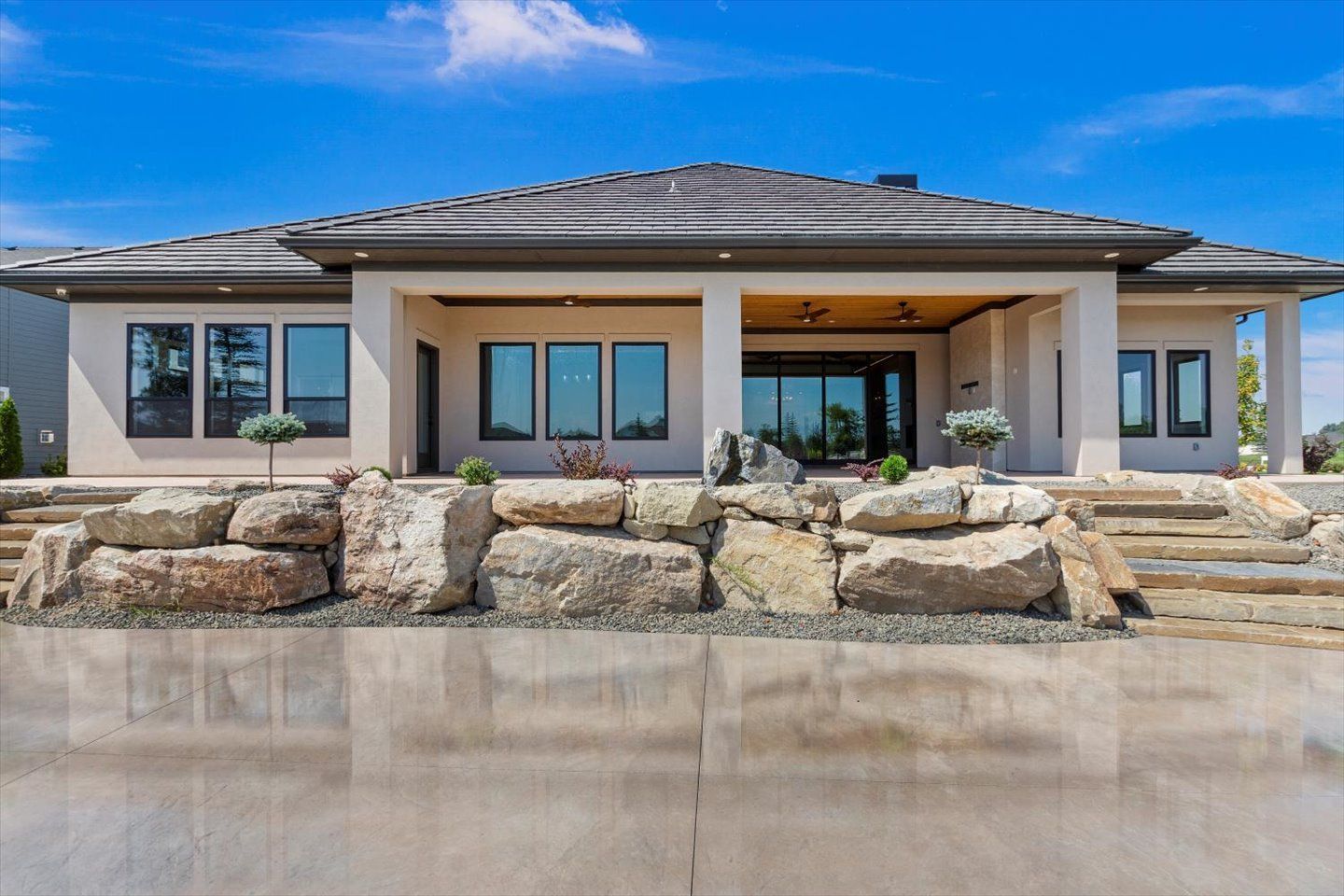 A large house with a lot of windows and stairs in front of it.