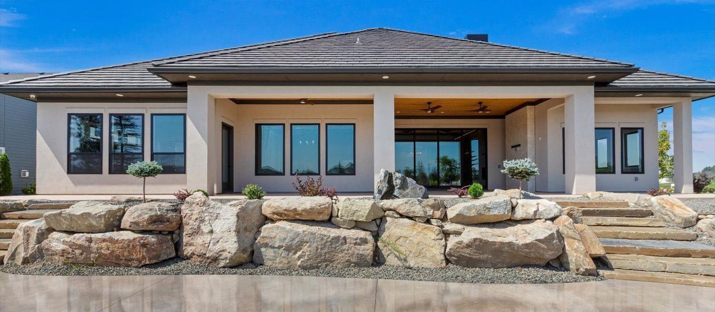 A large house with a lot of windows and stairs in front of it.