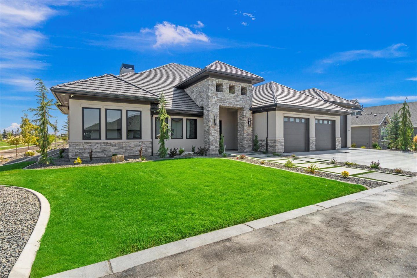 A large house with a lush green lawn in front of it.