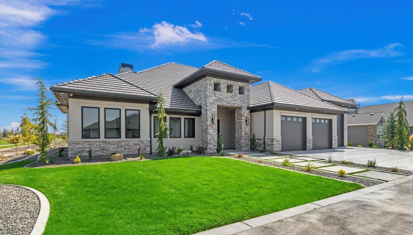 A large house with a lush green lawn in front of it.