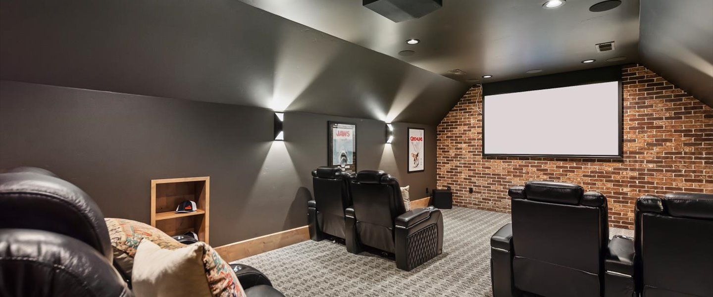 There is a projector screen in the middle of the room.