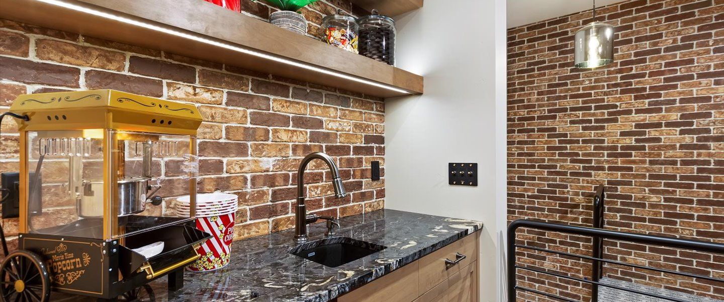 A kitchen with a popcorn machine and a sink.