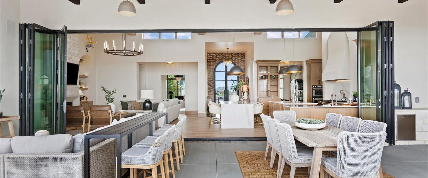 A living room and dining room in a house with sliding glass doors.