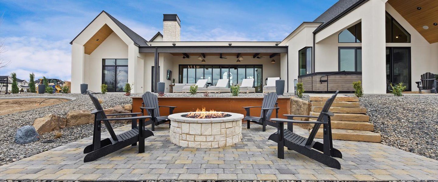 There is a fire pit in the backyard of a house.