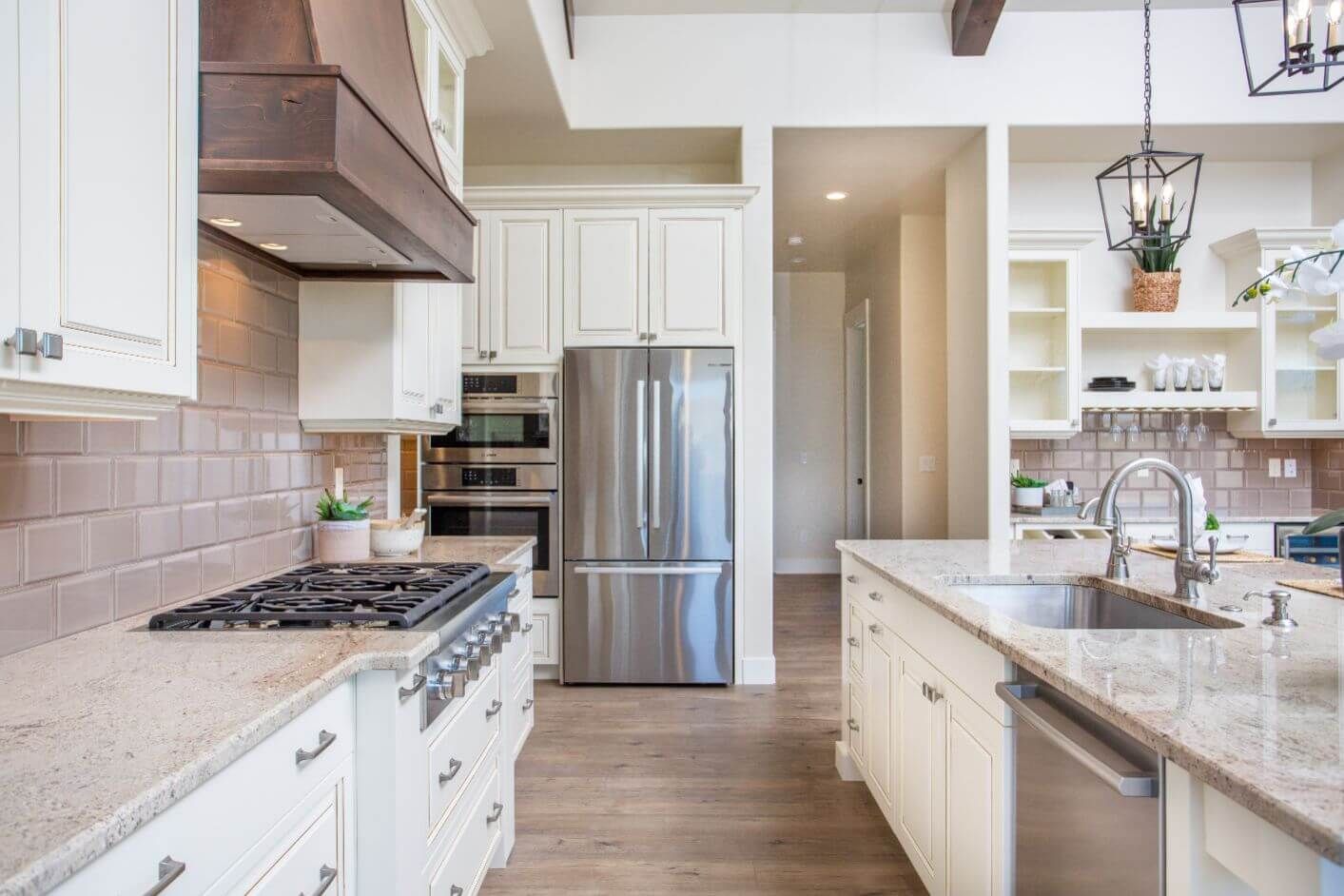 A kitchen with stainless steel appliances and granite counter tops.