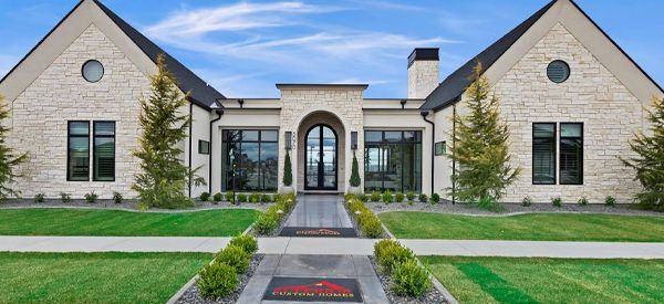 A large brick house with a walkway leading to it.
