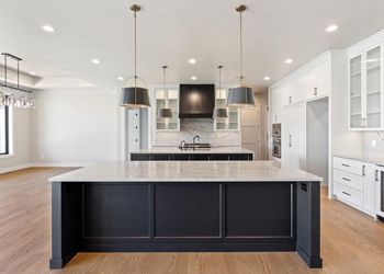 There is a large island in the middle of the kitchen.
