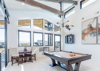 There is a pool table in the middle of the room.